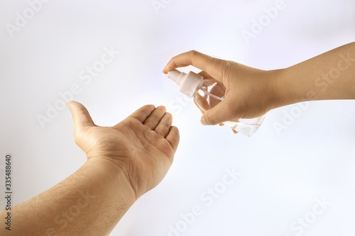 hands using sanitizer alcohol spray virus