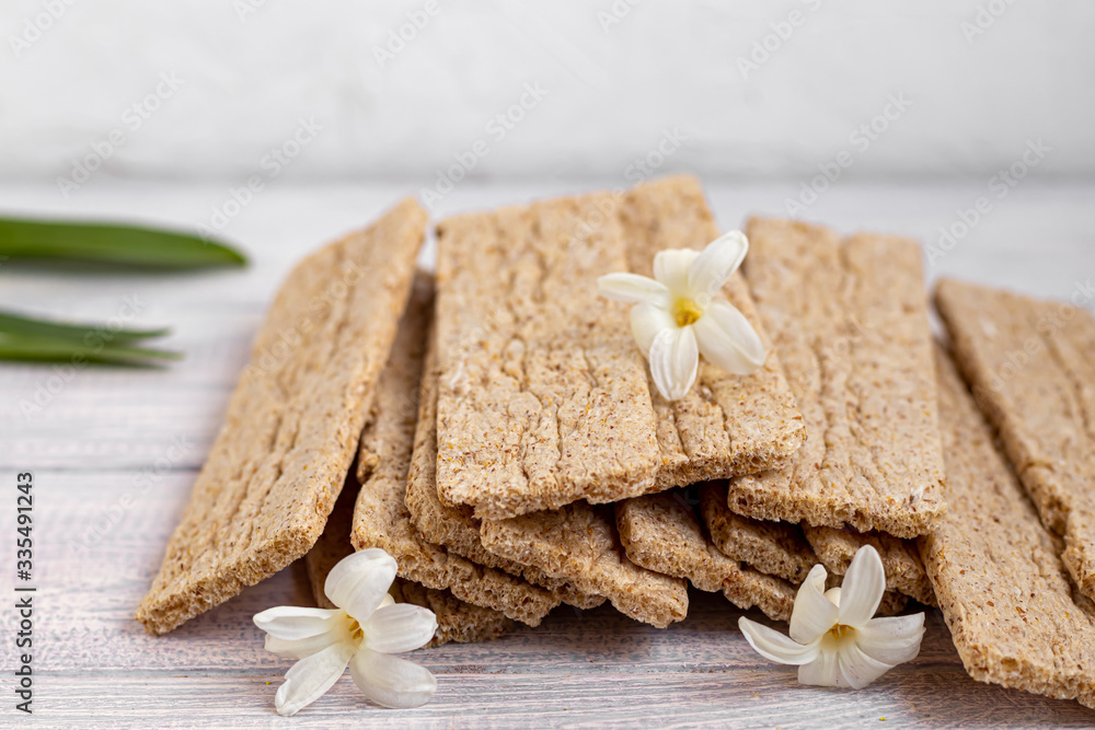 Diet crispy bread with bran on a light background. Healthy eating Vegetarian Cookies.