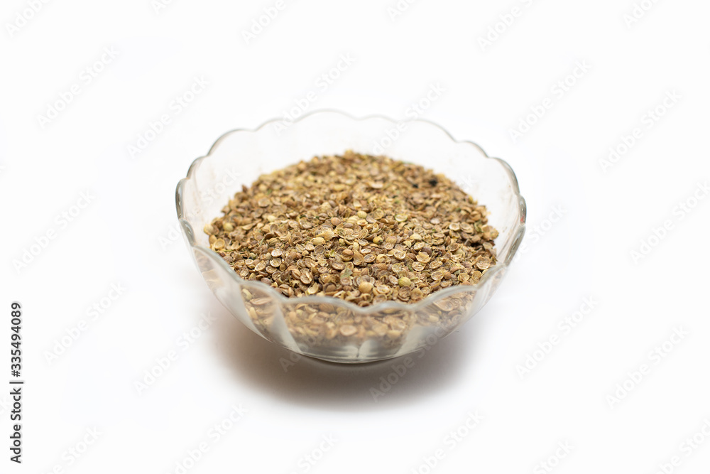 dry coriander in glass pot on white background dry coriander in glass pot on white background