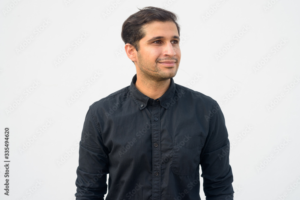 Portrait of young handsome Persian businessman thinking Portrait of young handsome Persian businessman thinking