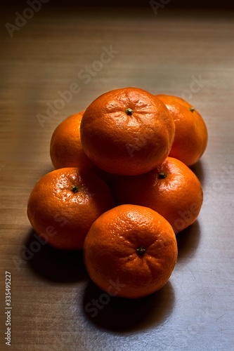 Six tangerine sweets on a wooden table