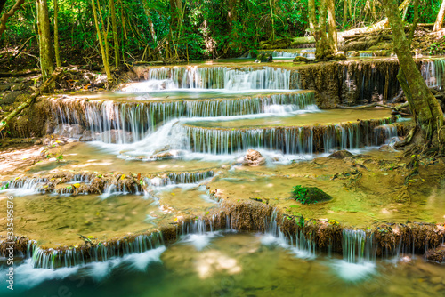 Waterfall in tropical deep forest green tree sunlight