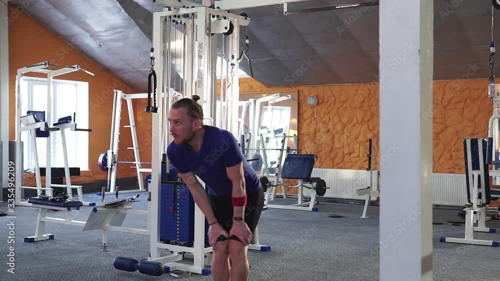 Young male person doing exercises at gym studio. Young male person doing exercises at gym studio.