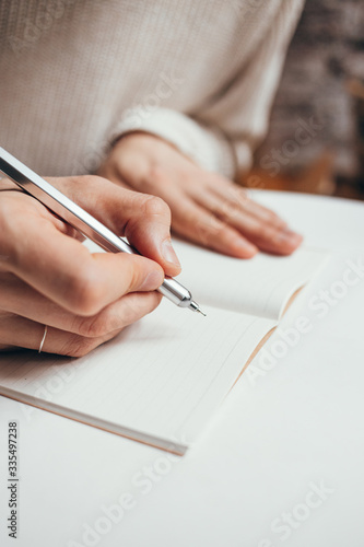 man writing a notes in notebook