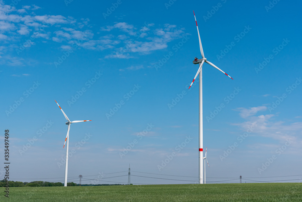 Modern wind energy turbines in a cornfield seen in Germany Modern wind energy turbines in a cornfield seen in Germany