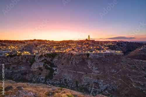 Obraz na płótnie The beautiful old town of Matera and the canyon of the Gravina river after sunse
