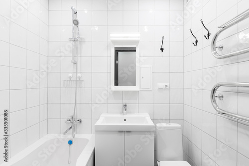 minimalist white bathroom with mirror