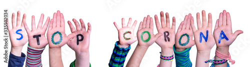 Children Hands Building Colorful English Word Stop Corona. White Isolated Background photo