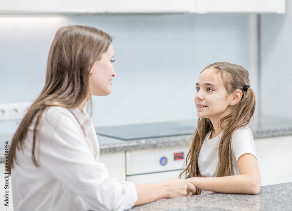 Mom talks with young daughter at home Mom talks with young daughter at home