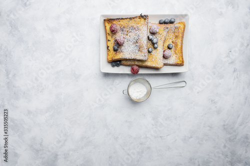 Ingredients and preparation of delicious sweet French toast with cinnamon and vanilla. Quick and easy breakfast, top view photo