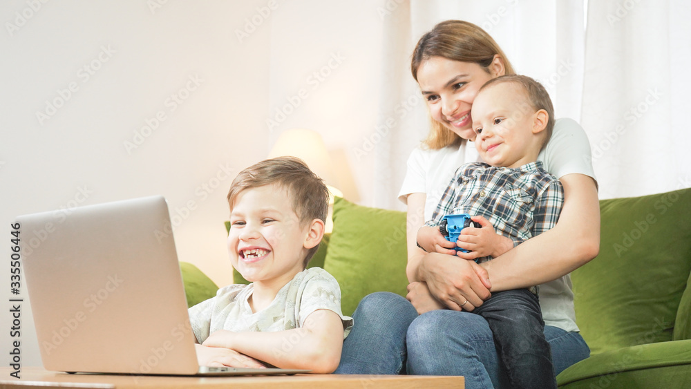 Beautiful mom with sons having a facetime video call. Happy family taking selfies and video chatting at home. Mother's day, unity, connection concept. Beautiful mom with sons having a facetime video call. Happy family taking selfies and video chatting at home. Mother's day, unity, connection concept.