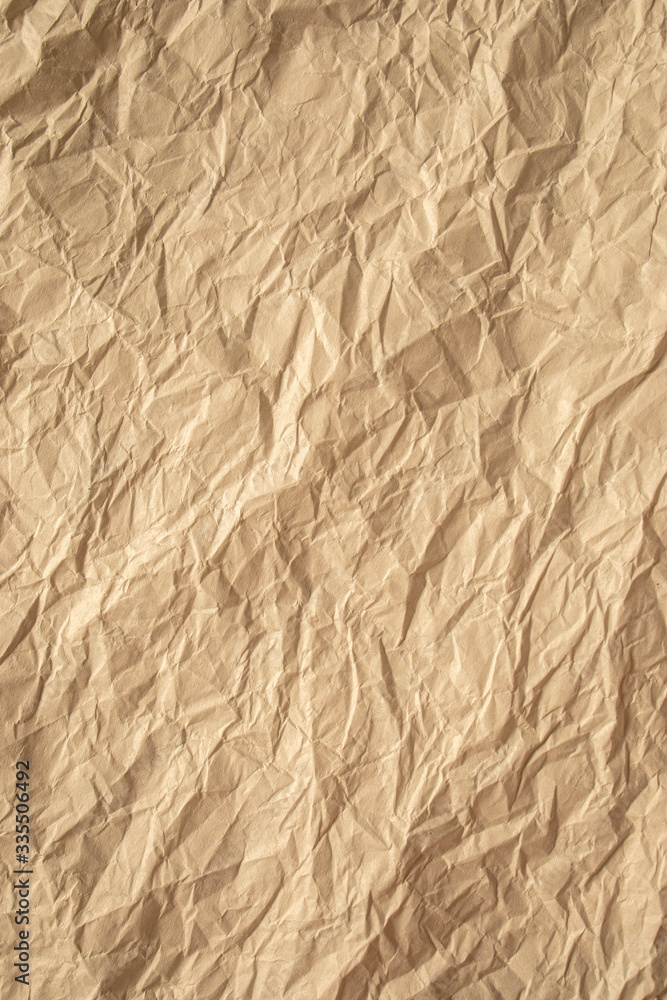 Fototapeta premium Brown crumpled paper close up texture background Vertical