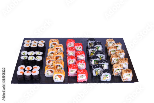 sushi set Tokushima rolls with fresh ingredients on black stone isolated on white background. Sushi menu. Japanese food.