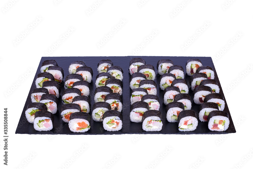 Maki Sushi set Futomaki rolls with fresh ingredients. Rolls on black stone isolated on white background. Sushi menu. Japanese food. Maki Sushi set Futomaki rolls with fresh ingredients. Rolls on black stone isolated on white background. Sushi menu. Japanese food.