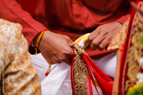 Traditional indian wedding ceremony, groom holding hand in bride hand photo