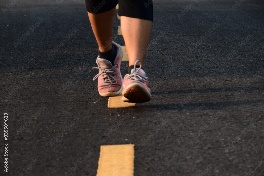 legs with shoes running on the road in outdoor for good healthy