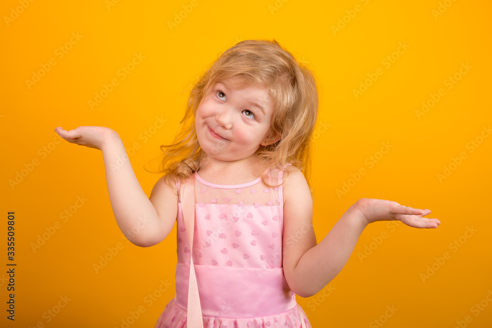 Funny surprised little girl spreading her arms to the sides showing that it is too late to make decisions Funny surprised little girl spreading her arms to the sides showing that it is too late to make decisions