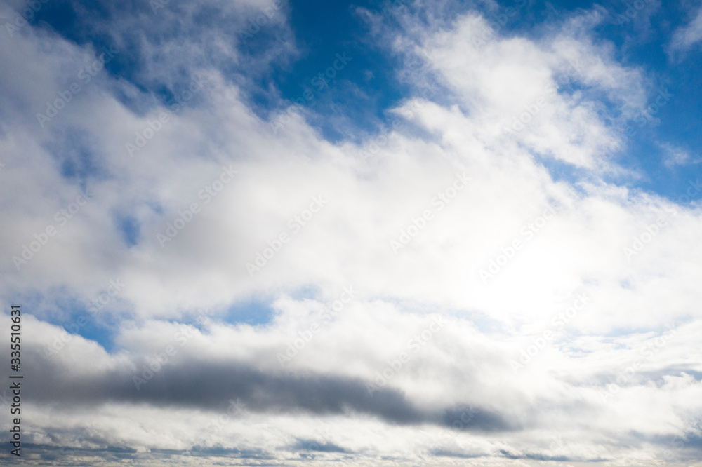 Obraz premium Aerial view white clouds in blue sky. View from drone. Aerial top view cloudscape. Texture of clouds. View from above. Sunrise or sunset over clouds. Panorama clouds