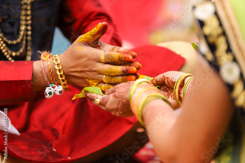 Indian wedding photography, Haldi ceremony groom hands © Neha