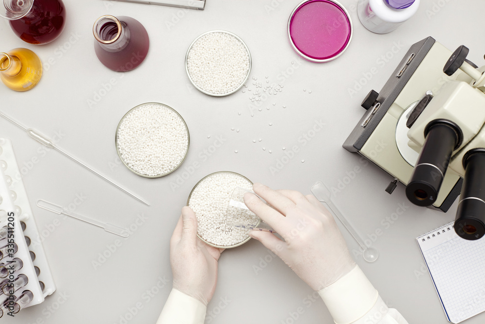 Top view of a desk in a chemistry lab with chemicals, pipette and