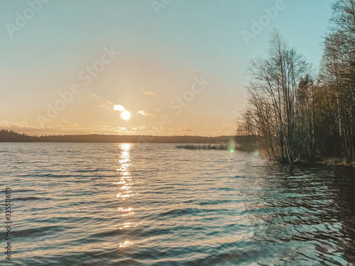 Beautiful sunrise on the lake in Sweden, Water, sun and sand.