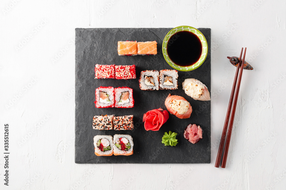 Japanese cuisine. Assorted sushi maki gunkan roll on white table