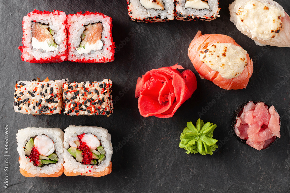 Japanese cuisine. Assorted sushi maki gunkan roll on white table
