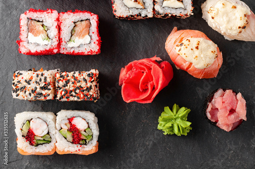Japanese cuisine. Assorted sushi maki gunkan roll on white table