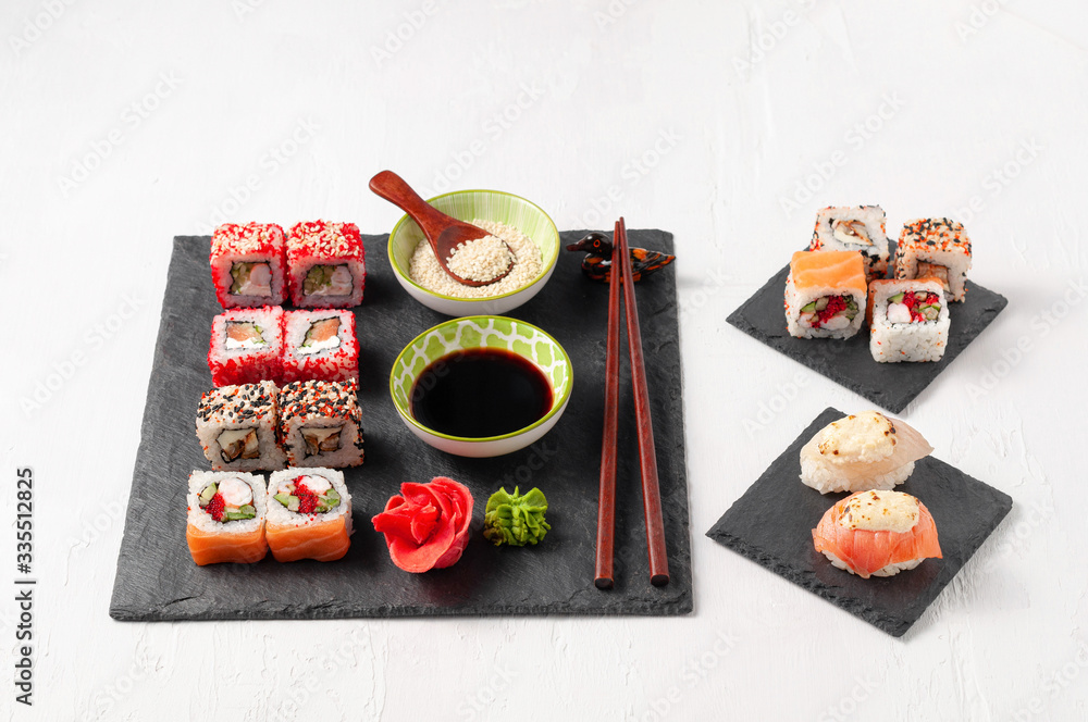 Japanese cuisine. Assorted sushi maki gunkan roll on white table