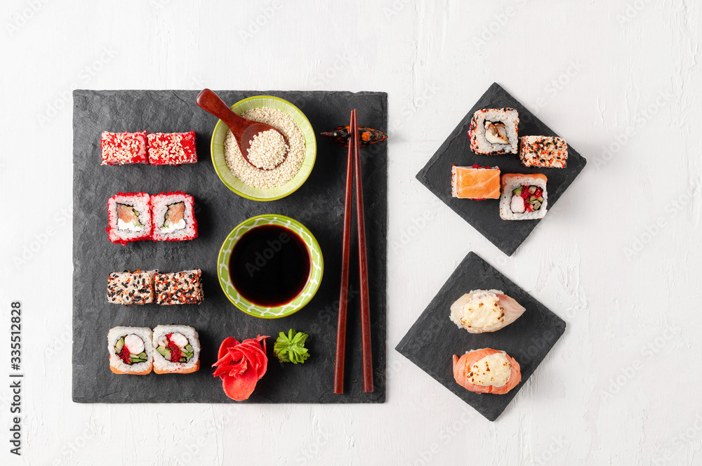 Japanese cuisine. Assorted sushi maki gunkan roll on white table