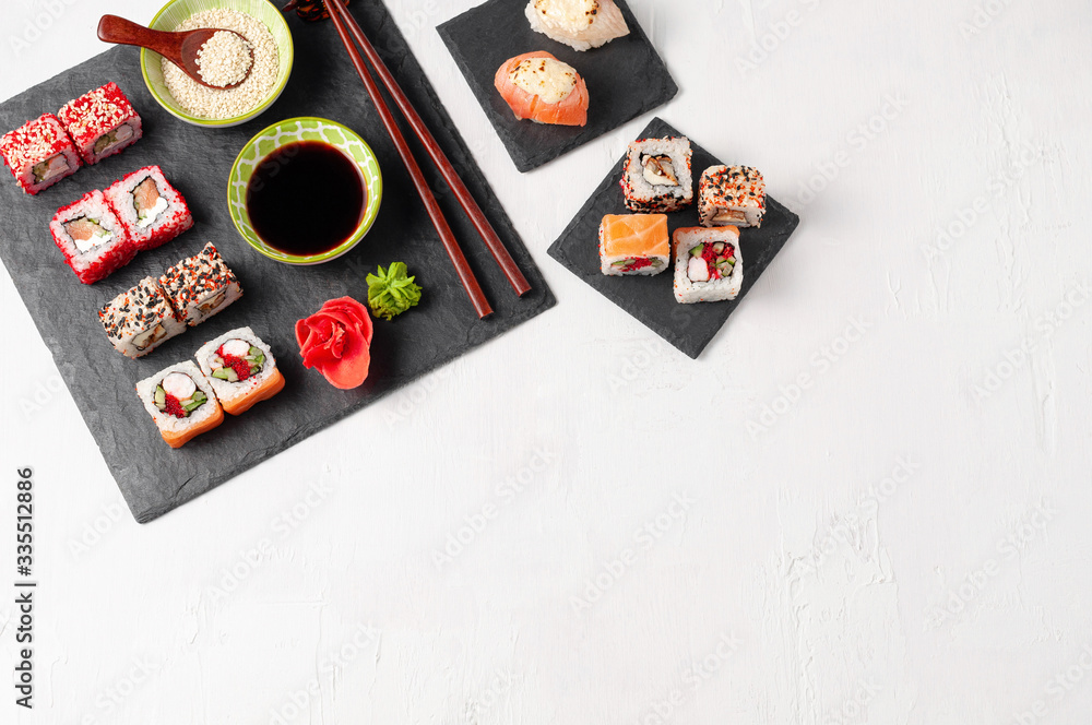Japanese cuisine. Assorted sushi maki gunkan roll on white table