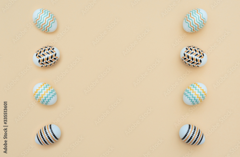 Fototapeta premium Decorated Easter eggs lie on the yellow background. Happy Easter holiday and minimalism concept. Greeting, invitation card. Flat lay style with copy space.