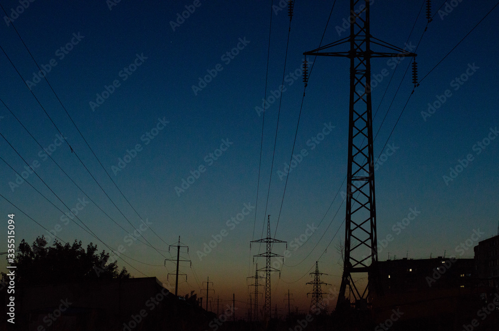 Fototapeta premium power lines against the background of the sunset sky