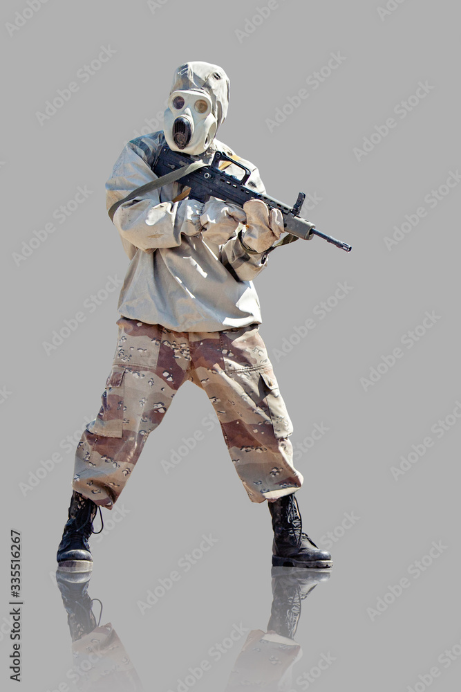Soldier in protective clothes and mask with the rifle. Isolated on grey background. Soldier in protective clothes and mask with the rifle. Isolated on grey background.