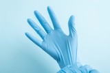 Medical staff hands wearing blue disposable gloves