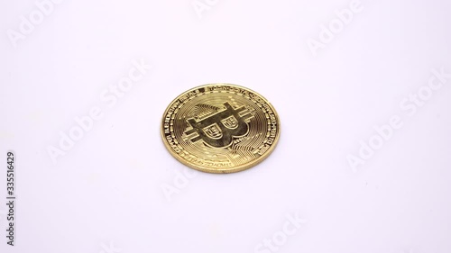 Golden Bitcoin coin rotates on a white background. Footage. 360 rotation.