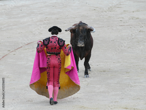 Spanish torero performing a bullfight at a big arena
