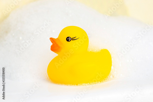 Rubber duck in the foam. minimally creative concept. bathing children