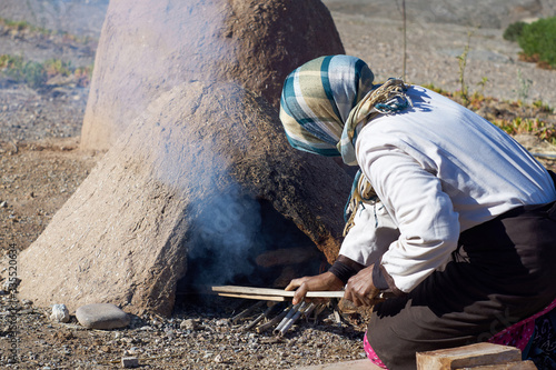 Cooking in traditional Moroccan earth ovens made of sandstone and mud