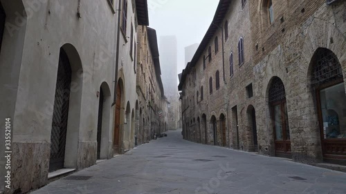 Empty street of San Gimignano medieval town, Tuscany, Italy. No people, all closed due to quarantine coronavirus effects