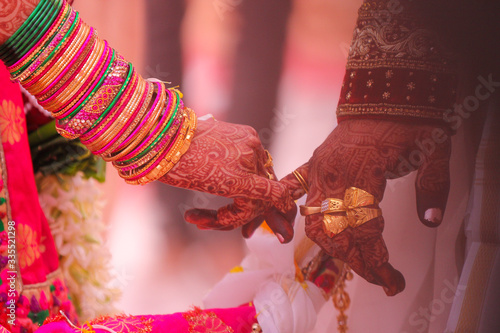 Traditional indian wedding ceremony, groom holding hand in bride hand photo