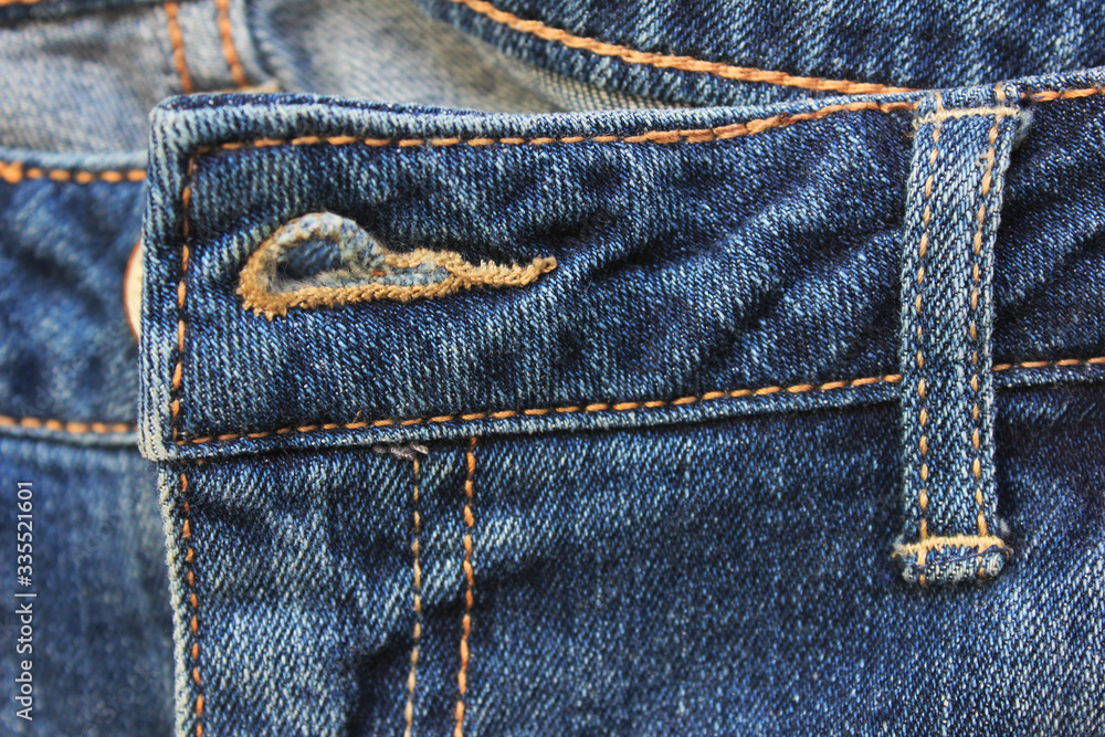 Blue denim jeans design detail with seams and buttonhole close up view. Classic fashion jeans design, simple natural pattern canvas of empty dark blue denim jean background Blue denim jeans design detail with seams and buttonhole close up view. Classic fashion jeans design, simple natural pattern canvas of empty dark blue denim jean background