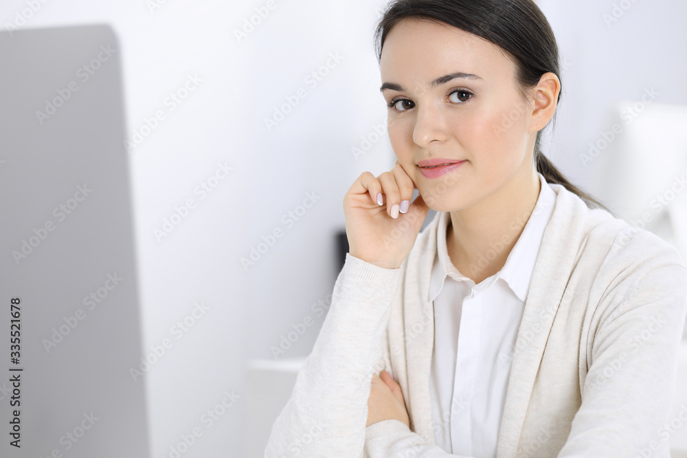 Casual dressed business woman working with computer in office. Lawyer or accountant at work Casual dressed business woman working with computer in office. Lawyer or accountant at work