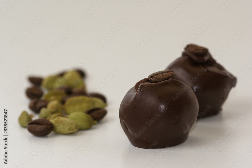 Dark brown chocolate pralines filled with roasted coffee beans and cream Dark brown chocolate pralines filled with roasted coffee beans and cream