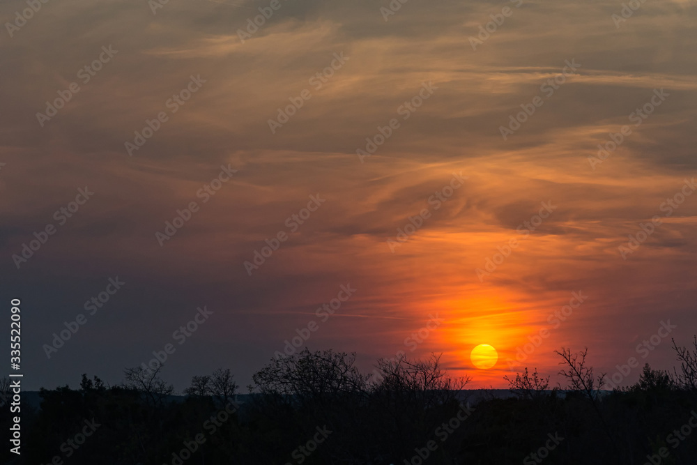 Evening nature with scenic sunset sky against orange clouds background in Croatia.