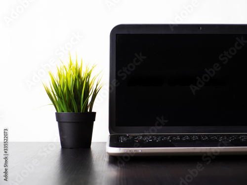 Mockup with a black screen for your design. Laptop on the table , workplace in a minimalistic style,