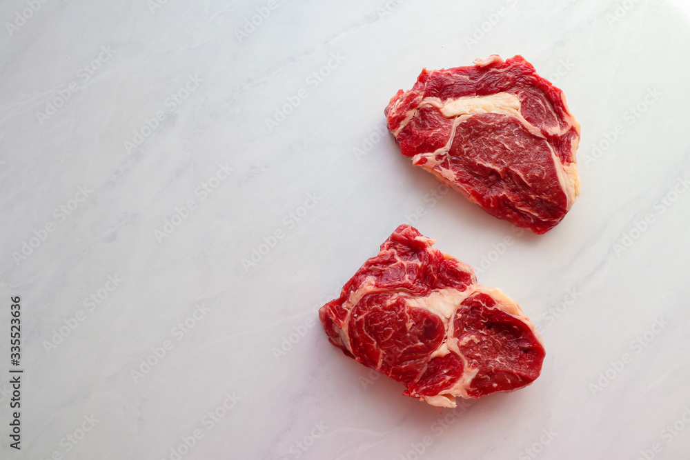 Fresh raw steaks on light background Fresh raw steaks on light background