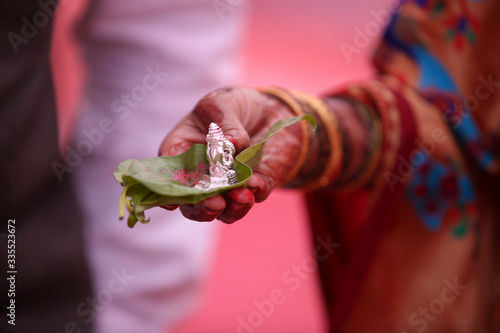 Photography Indian wedding ceremony : Decorative Flower and coconut with god sculptures or p