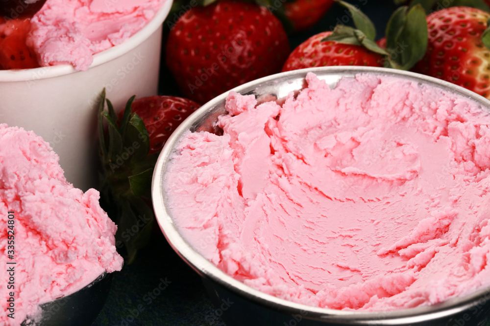Strawberry ice cream scoop with fresh strawberries