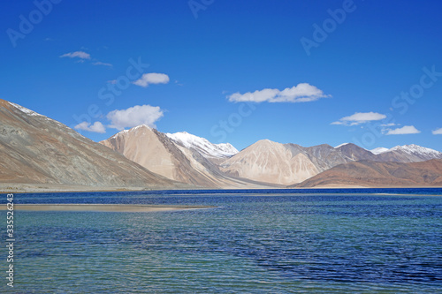 Lakescape Nature Scene of Pangong tso or Pangong Lake with Snow mountain background is best famous destination at Leh Ladakh ,Jammu and Kashmir , India - Blue nature travel Background - travel